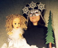 The Snow Maiden moves across the winter snow as masked puppeteer Melanie Zimmer represents the forces of winter