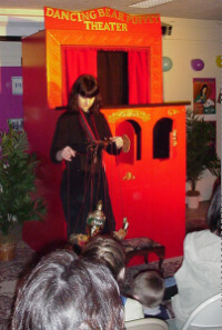 Melanie performing with Maiyarap, a large puppet from Thailand